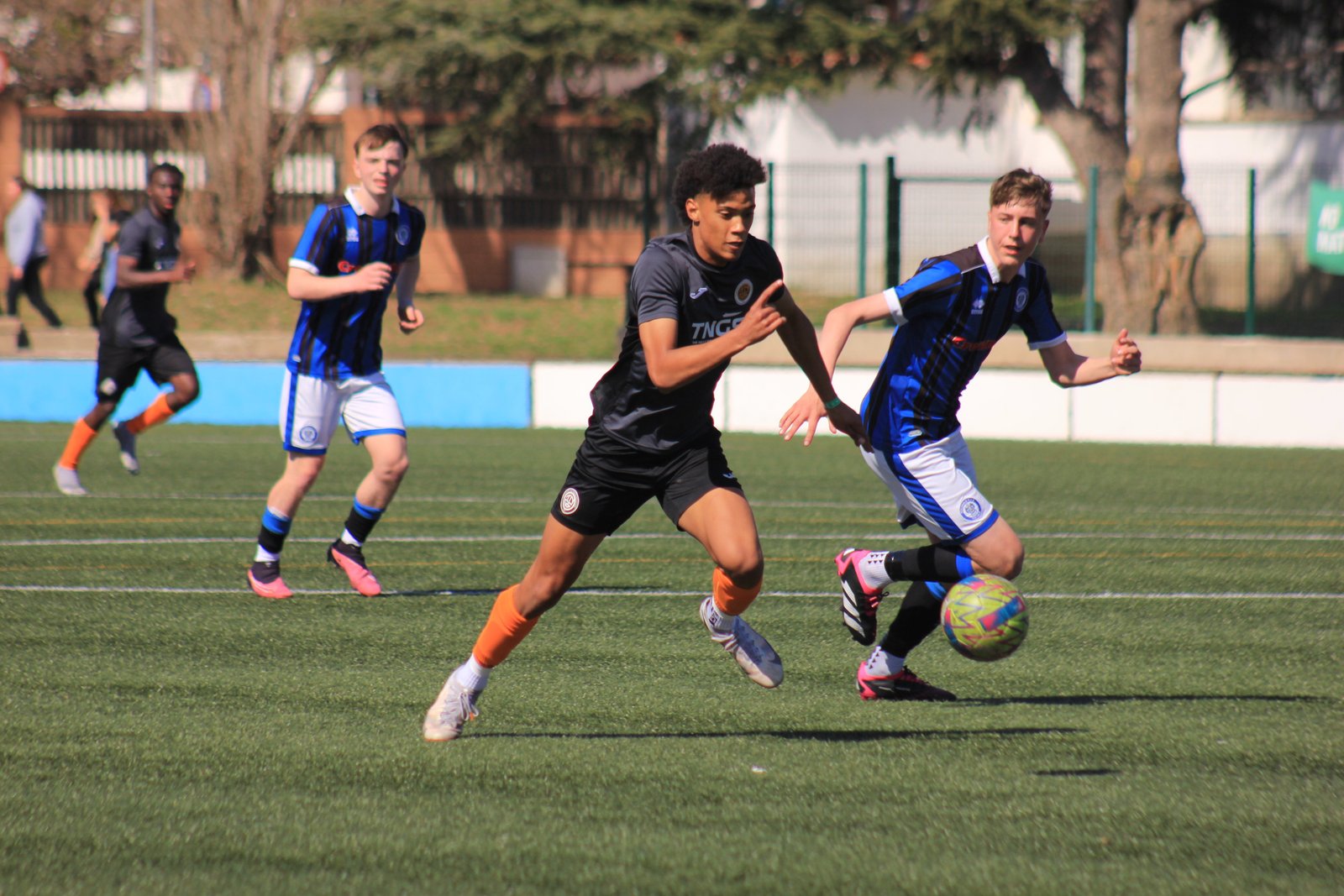 How does training at an international football academy boost your professional career?